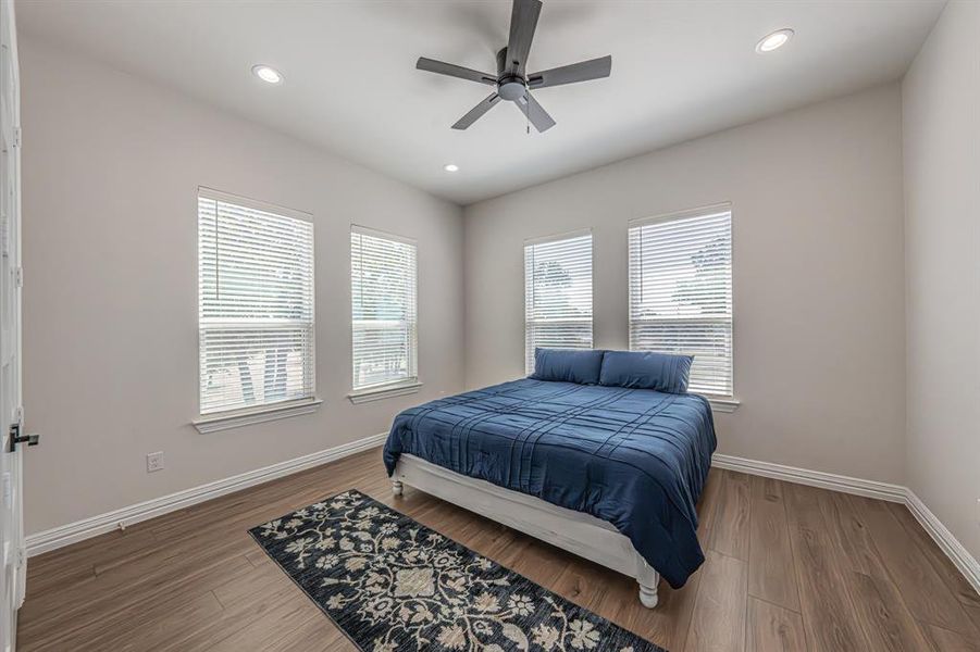 Bedroom with a ceiling fan, wood finished floors, and recessed lighting Bedroom with a ceiling fan, wood finished floors, and recessed lighting