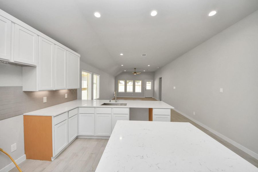 The open concept effortlessly connects the kitchen to the expansive family room, forming a perfect hub for gatherings. This seamless flow creates an inviting space where cooking and socializing come together harmoniously. Sample photo of completed home with similar floor plan. Actual colors and selections may vary.