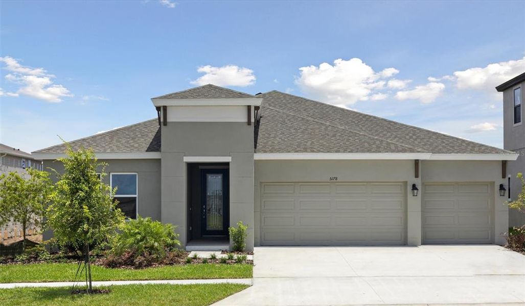 Front exterior of a new home in Waterset, Apollo Beach, FL, highlighting curb appeal (Image 1).