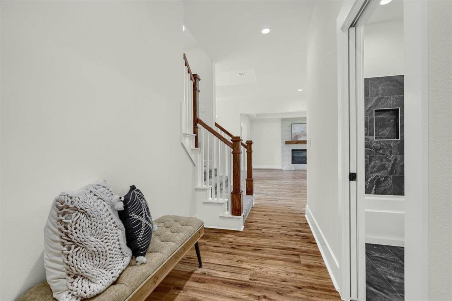 Corridor with hardwood / wood-style floors