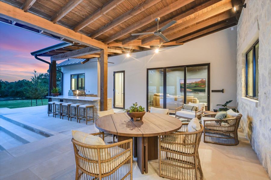 View of patio / terrace with outdoor dining area, a ceiling fan, exterior bar, and a grill View of patio / terrace with outdoor dining area, a ceiling fan, exterior bar, and a grill