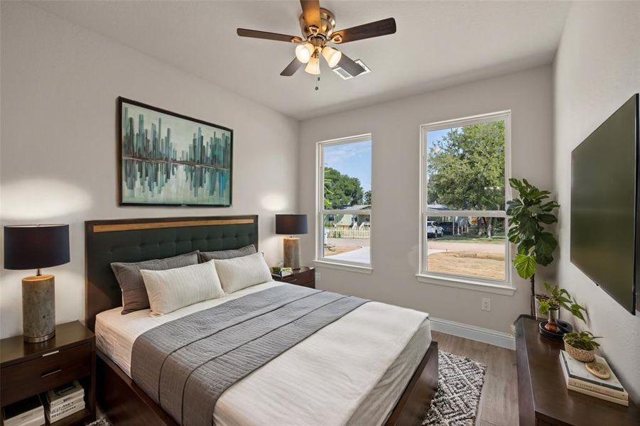 Bedroom featuring wood-type flooring and ceiling fan