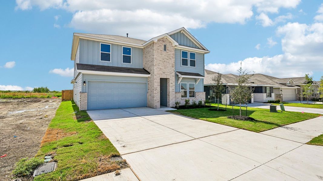 Front exterior of a new home in Carillon, Manor, TX, highlighting curb appeal (Image 23).