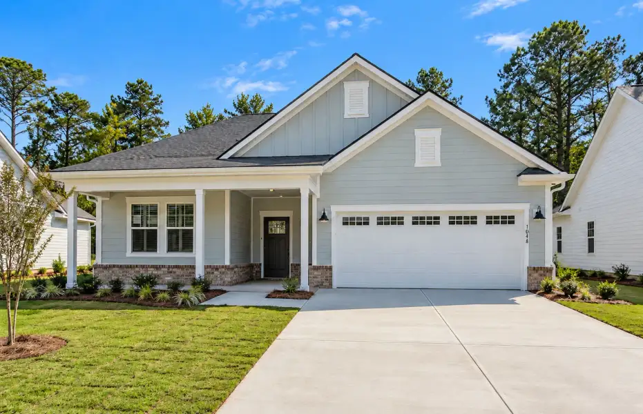 Front exterior of a new home in Southport Meadows, Southport, NC, highlighting curb appeal (Image 2). Front exterior of a new home in Southport Meadows, Southport, NC, highlighting curb appeal (Image 2).