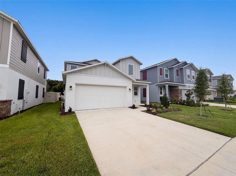 Front exterior of a new home in Wynnstone, Davenport, FL, highlighting curb appeal (Image 14). Front exterior of a new home in Wynnstone, Davenport, FL, highlighting curb appeal (Image 14).