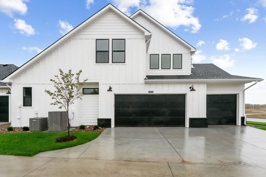 Front exterior of a new home in The Courtyards at The Moorings, Wichita, KS, highlighting curb appeal (Image 2). Front exterior of a new home in The Courtyards at The Moorings, Wichita, KS, highlighting curb appeal (Image 2).