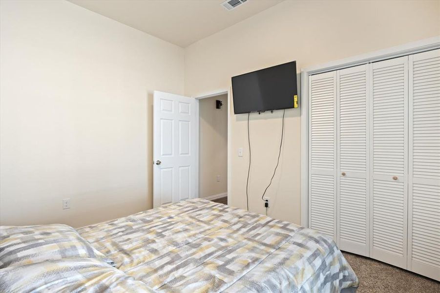 Carpeted bedroom featuring a closet