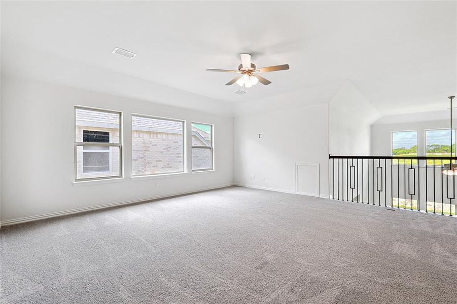 Empty room featuring carpet and ceiling fan