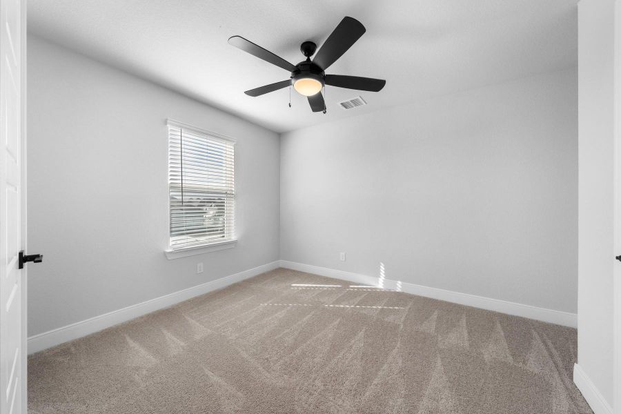 Unfurnished room with light carpet and a ceiling fan