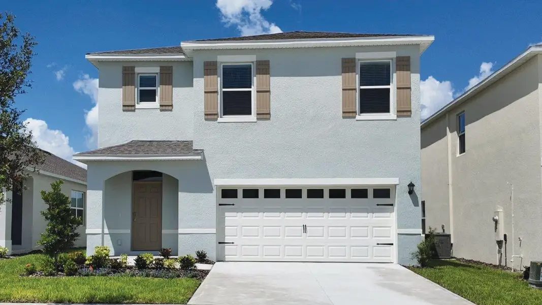 Front exterior of a new home in Wynnstone, Davenport, FL, highlighting curb appeal (Image 1). Front exterior of a new home in Wynnstone, Davenport, FL, highlighting curb appeal (Image 1).