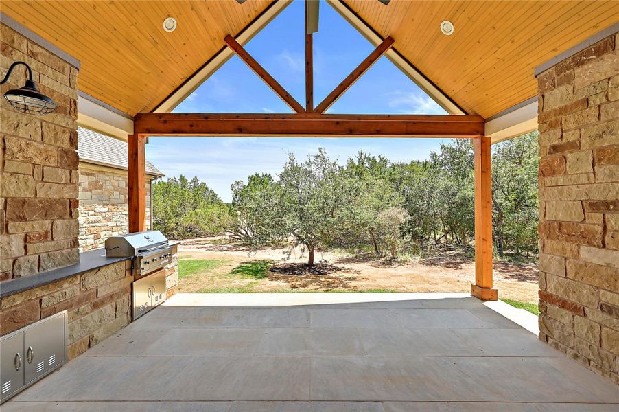 The rear patio features cedar beams in a starburst pattern as well as flagstone covered flooring.