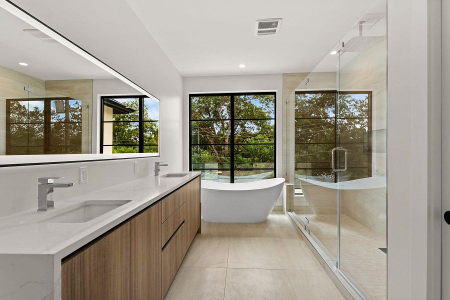 Clean lines and a free-standing tub define this modern bathroom with a glass-enclosed shower.