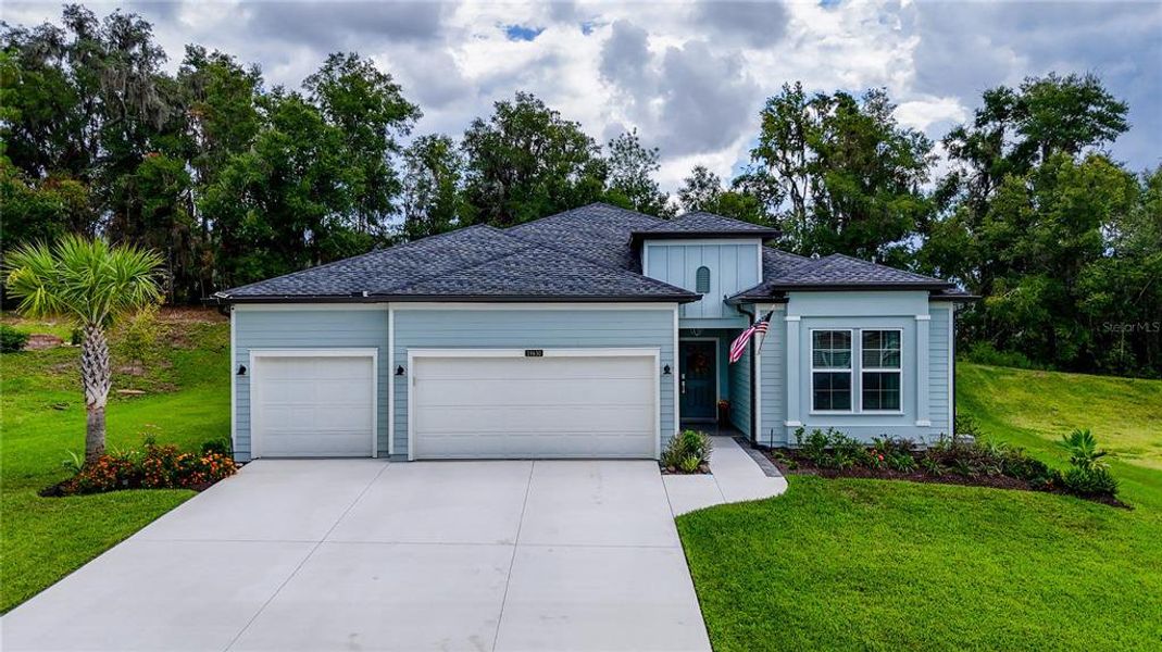 Front exterior of a new home in Grand Park North, Dunnellon, FL, highlighting curb appeal (Image 1).