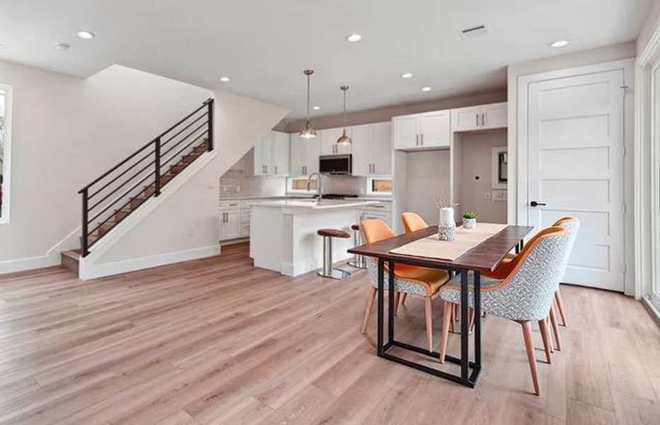 Dining room with stairs, recessed lighting, and light wood finished floors Dining room with stairs, recessed lighting, and light wood finished floors