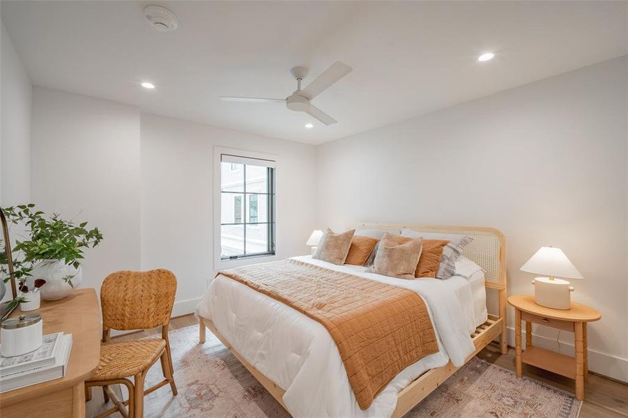 Bedroom with hardwood / wood-style floors and ceiling fan