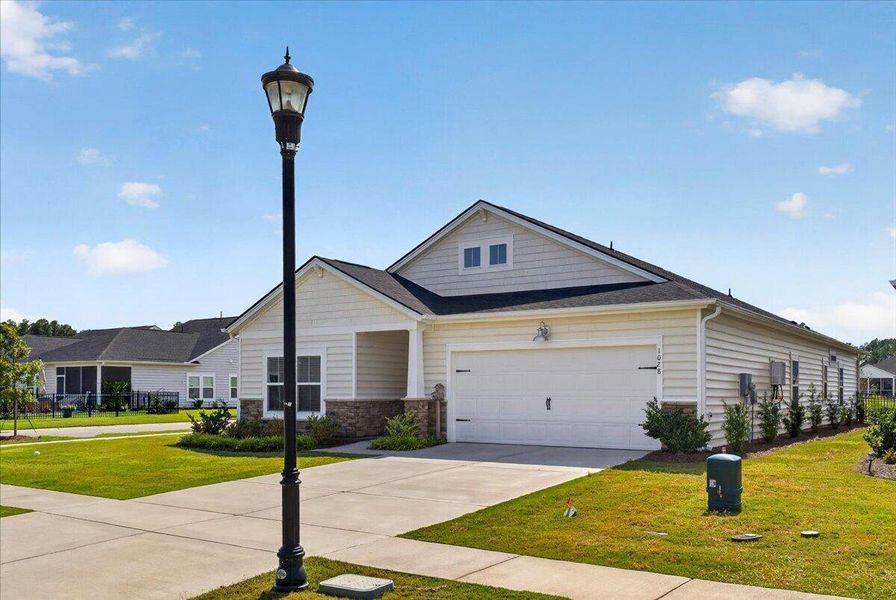 Front exterior of a new home in Horizons at Summers Corner | 55+, Summerville, SC, highlighting curb appeal (Image 26). Front exterior of a new home in Horizons at Summers Corner | 55+, Summerville, SC, highlighting curb appeal (Image 26).