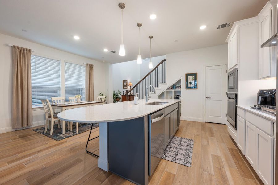 A luminous kitchen with a large island offers seamless integration into the home's open floor plan. A luminous kitchen with a large island offers seamless integration into the home's open floor plan.