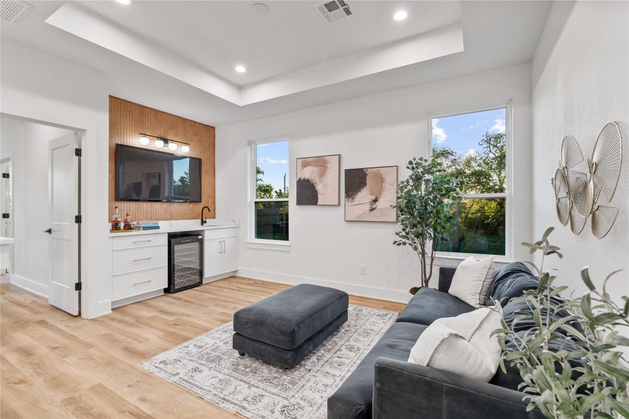 A versatile upstairs flex space designed for entertainment, complete with a built-in media center, a sleek wet bar, and a dedicated wine fridge area. A versatile upstairs flex space designed for entertainment, complete with a built-in media center, a sleek wet bar, and a dedicated wine fridge area.