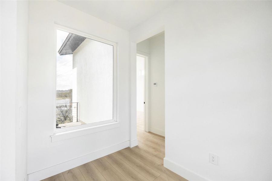 Unfurnished room featuring baseboards and light wood finished floors