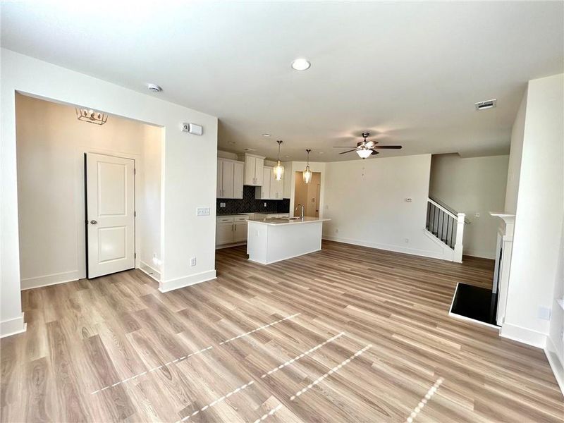 Unfurnished living room with light hardwood / wood-style flooring and ceiling fan