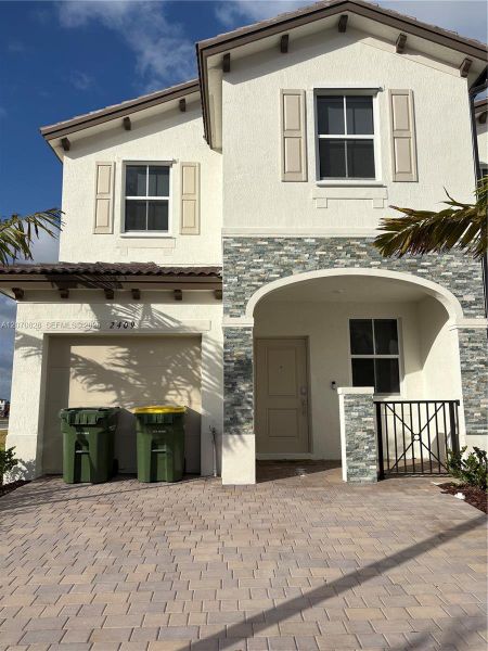 Front exterior of a new home in , Homestead, FL, highlighting curb appeal (Image 1). Front exterior of a new home in , Homestead, FL, highlighting curb appeal (Image 1).