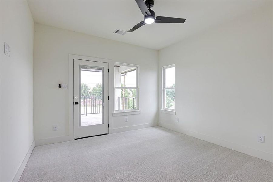 Empty room featuring carpet flooring and ceiling fan