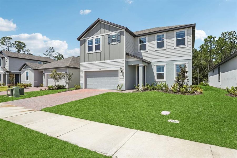 Front exterior of a new home in Legends Preserve - Signature Series, Daytona Beach, FL, highlighting curb appeal (Image 24).