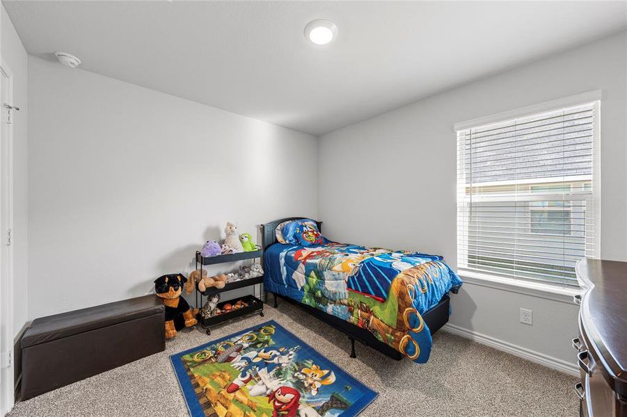 Carpeted bedroom with baseboards