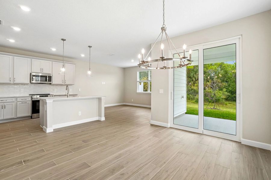 As you enter into the open concept living space you are welcomed into the dining space that looks out at the covered lanai