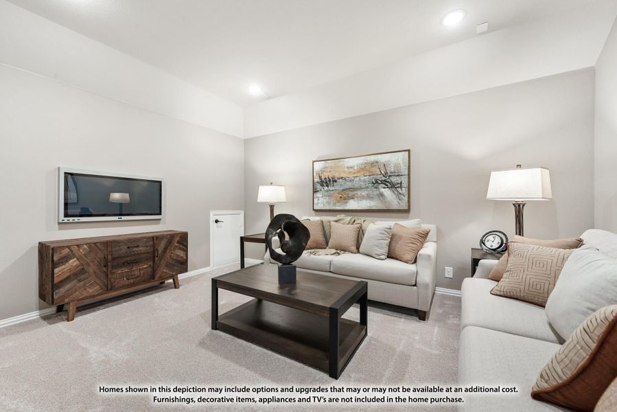Living room with beige carpet, wall-mounted TV, wood credenza, and neutral sofa seating area