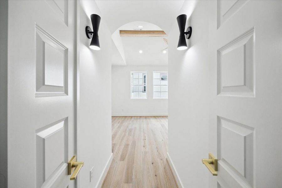 Entry into primary suite with additional lighting.