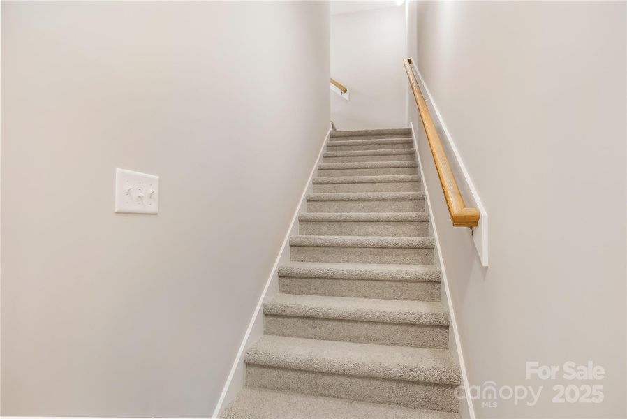 Stairs leading to 3rd bedroom above garage.