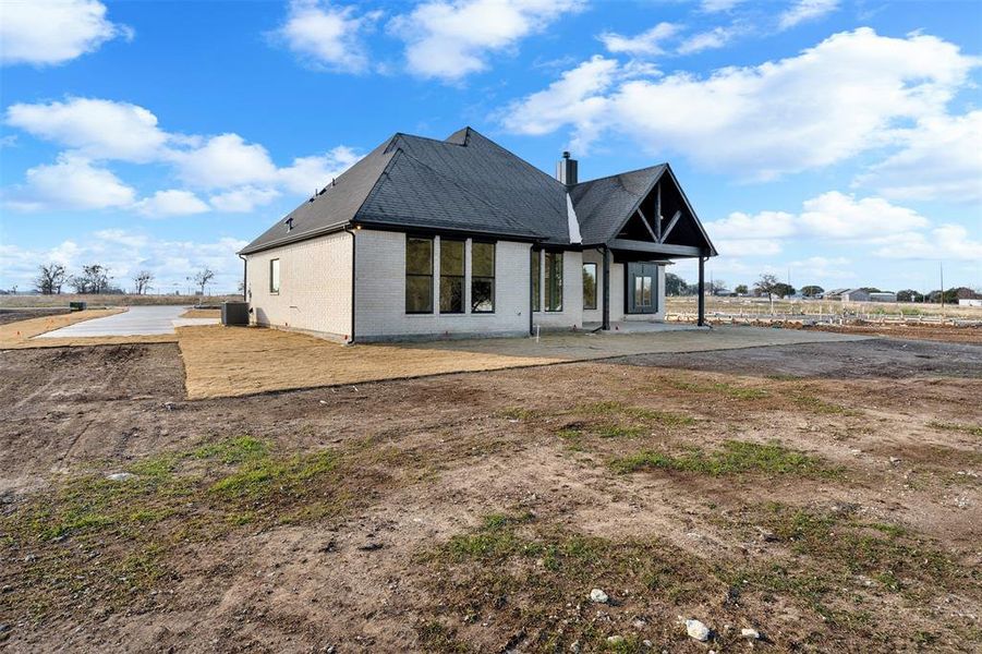 Back of property with a patio and central air condition unit