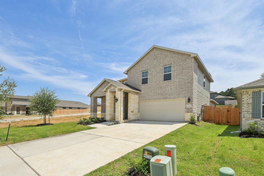 Front exterior of a new home in Pine Lake Cove - Premier Series, Montgomery, TX, highlighting curb appeal (Image 2). Front exterior of a new home in Pine Lake Cove - Premier Series, Montgomery, TX, highlighting curb appeal (Image 2).