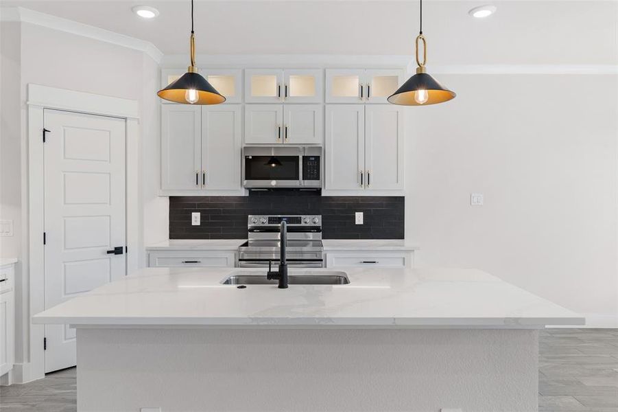 Kitchen featuring stainless steel appliances, a center island with sink, and sink