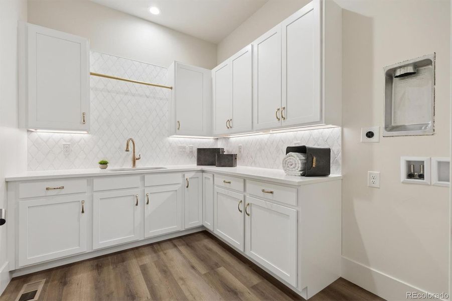 Oversized laundry w/utility sink & plenty of storage