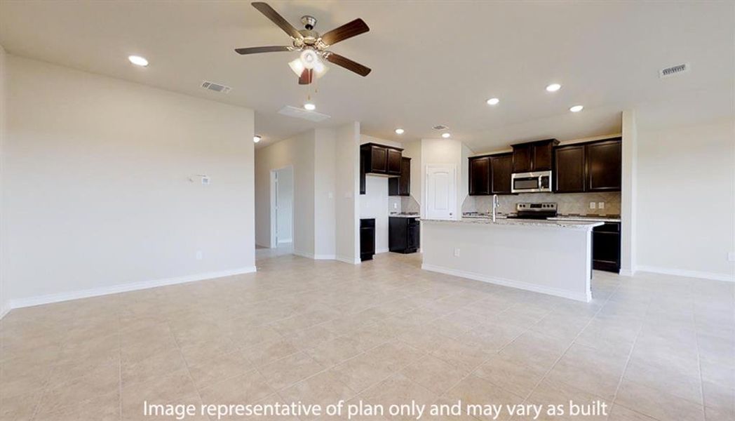 Kitchen featuring dark brown cabinetry, recessed lighting, an island with sink, open floor plan, and a ceiling fan Kitchen featuring dark brown cabinetry, recessed lighting, an island with sink, open floor plan, and a ceiling fan