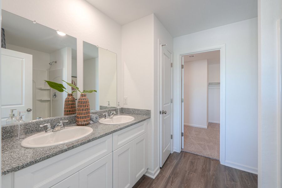 A bathroom with a sink and a mirror. A bathroom with a sink and a mirror.