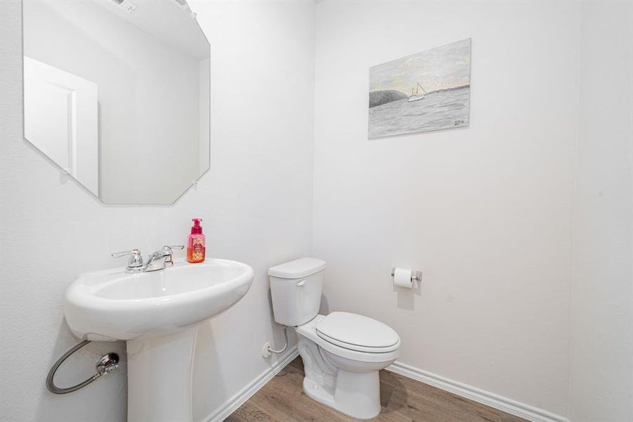 Bathroom featuring wood finished floors and baseboards Bathroom featuring wood finished floors and baseboards