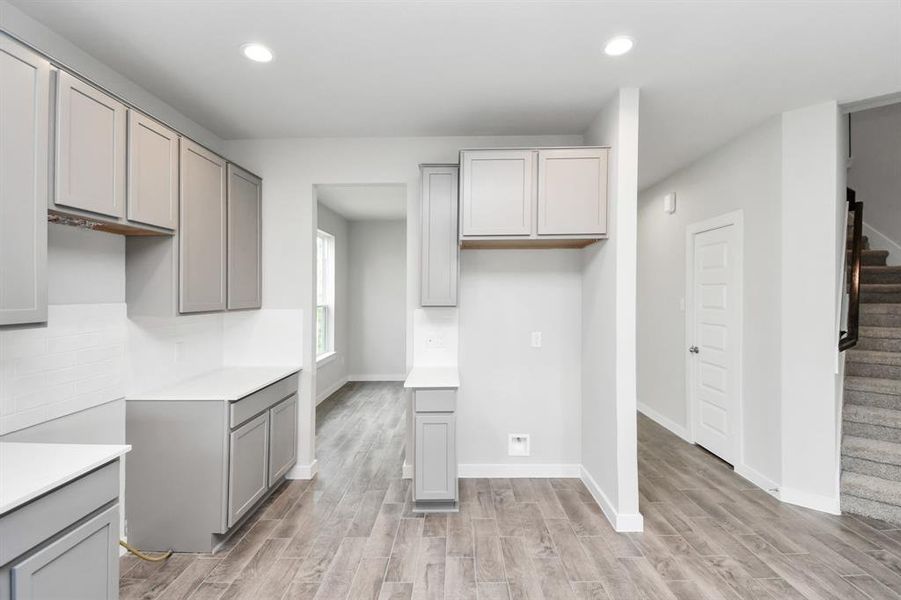 Discover another perspective of this stunning kitchen, generously appointed with an abundance of counter space. Sample photo of completed home with same plan. Actual colors and selections may vary.