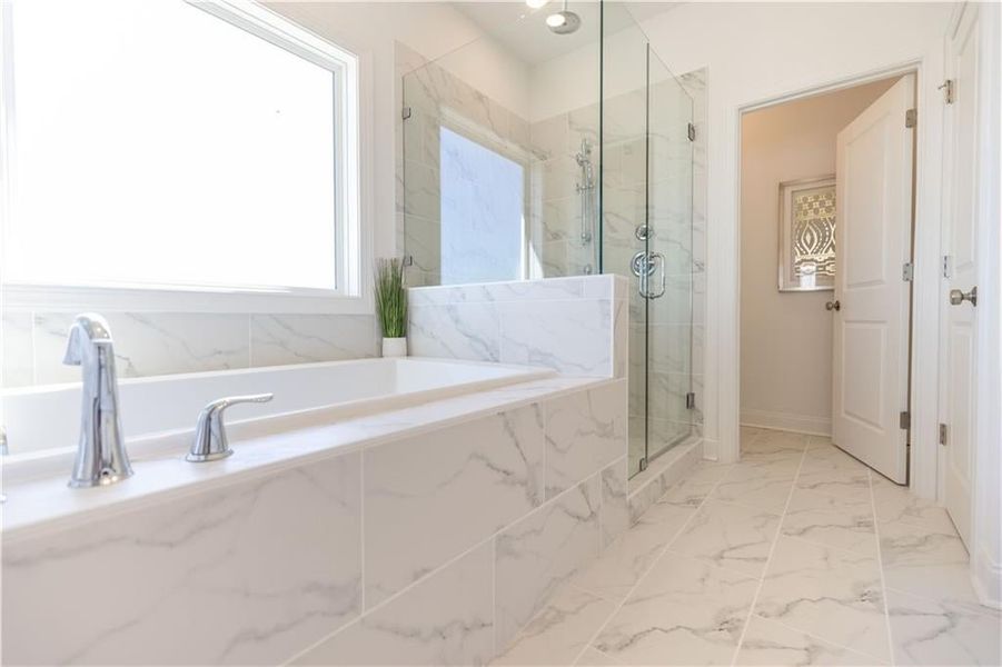 Soaking tub and stand alone shower. **Photos of model house and not of actual home - Photos for representation purposes only **