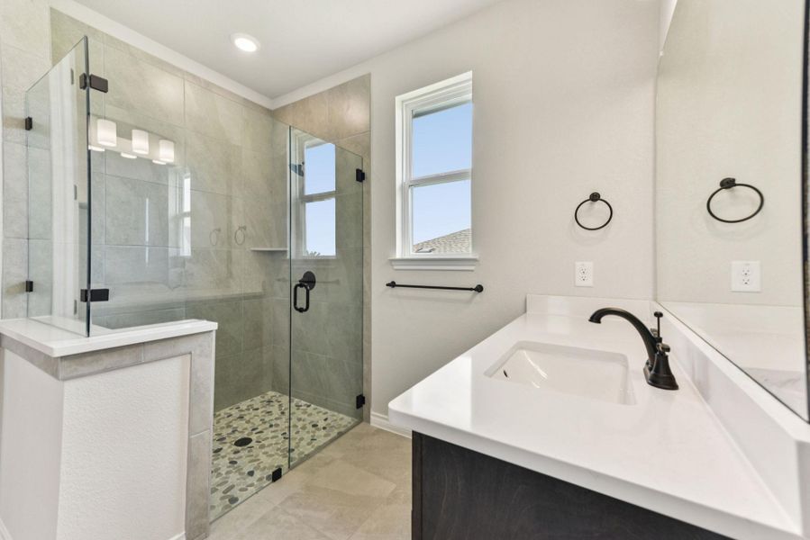 Full bathroom featuring vanity, a shower stall, and light tile patterned floors