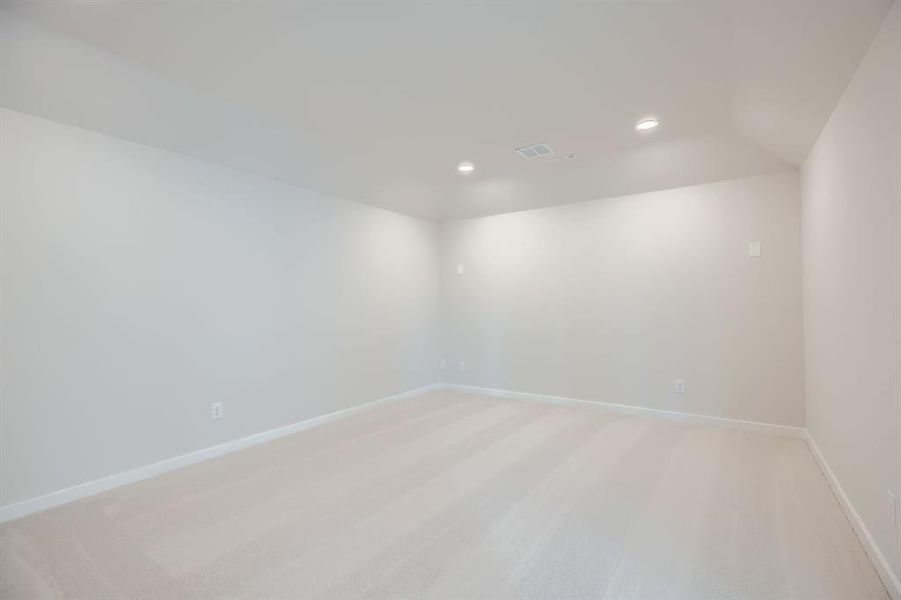 Spare room with recessed lighting and light carpet