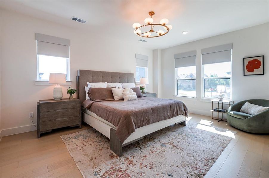Primary bedroom with plenty of natural light and room for sitting area.