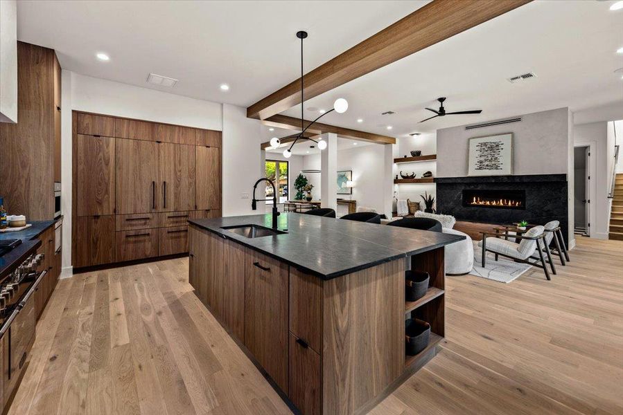 Kithchen island showing paneled Thermodor dishwasher and refrigerator.