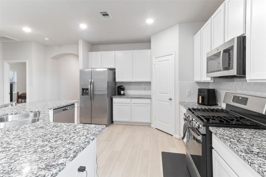 Modern kitchen with included stainless steel fridge. Modern kitchen with included stainless steel fridge.