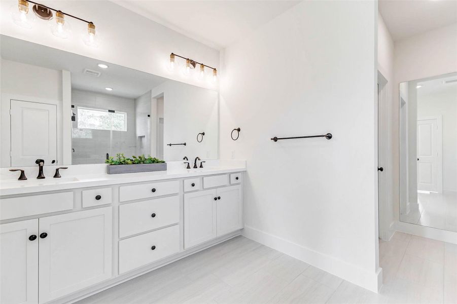 Notice the dressing mirror on the right that leads to the huge closet on the left. This dressing mirror is framed behind it in case the new home owner wants to create a door to the extra garage space or even create another room behind it.
