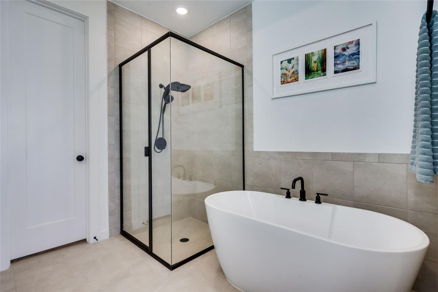 A sleek freestanding soaking tub and glass-enclosed shower create a modern bathroom retreat. A sleek freestanding soaking tub and glass-enclosed shower create a modern bathroom retreat.
