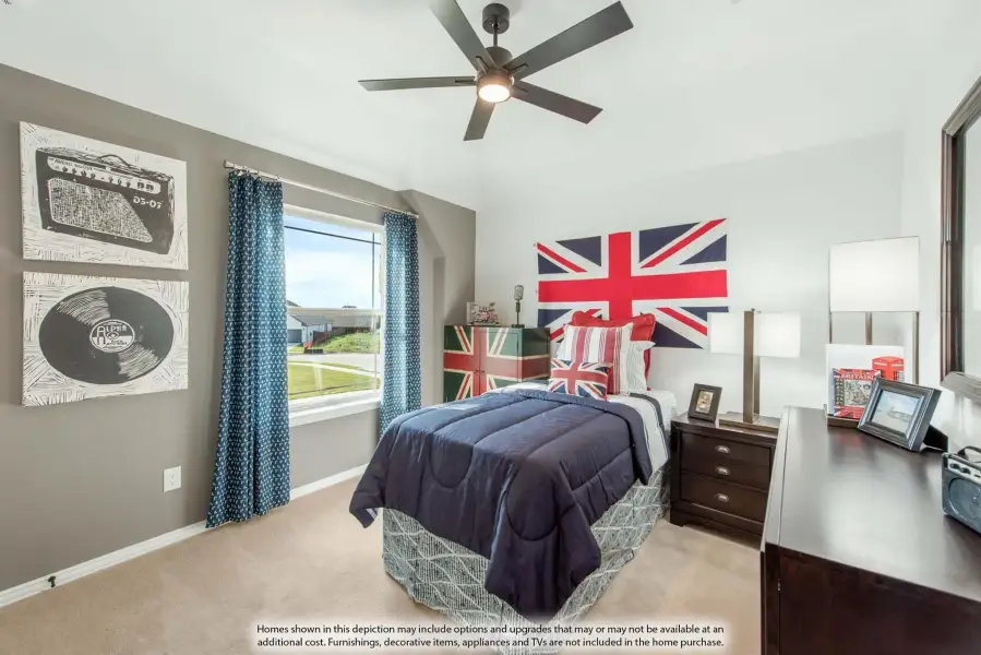 Bedroom with ceiling fan, navy bedding, Union Jack wall decor, and music-themed artwork on gray walls