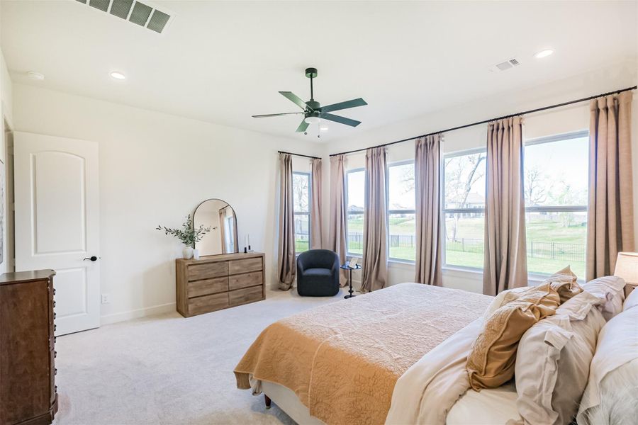 Another view of the serene primary bedroom and abundant natural light.